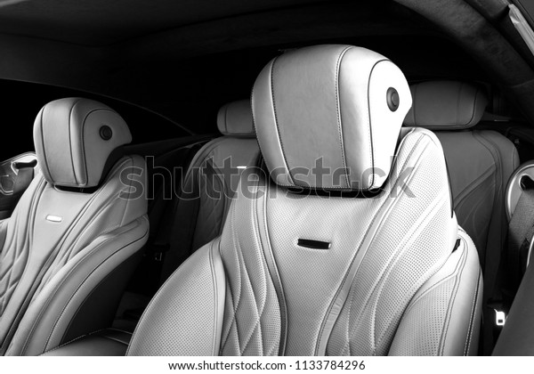 Modern Luxury car inside. Interior of\
prestige modern car. Comfortable leather seats. Perforated leather.\
Modern car interior details. Black and\
white