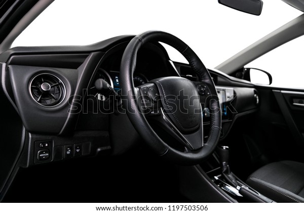 Modern Luxury car inside. Interior of prestige\
car. Comfortable leather seats. Black perforated leather cockpit\
with stitching. Steering wheel and dashboard. Automatic gear stick\
shift. Car detailing
