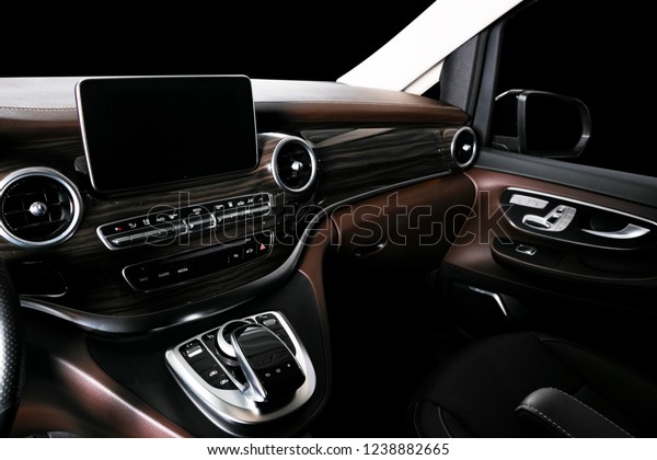 Modern Luxury car inside. Interior of prestige\
car. Comfortable leather seats. Brown perforated leather cockpit\
with stitching. Steering wheel and dashboard. Automatic gear stick\
shift. Car detailing