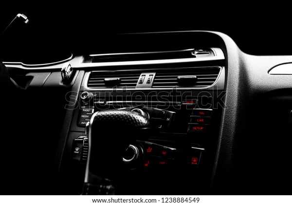 Modern Luxury car inside.\
Interior of prestige car.   Media, climate and navigation control\
buttons. Sound system. Modern car interior details. Black and\
white