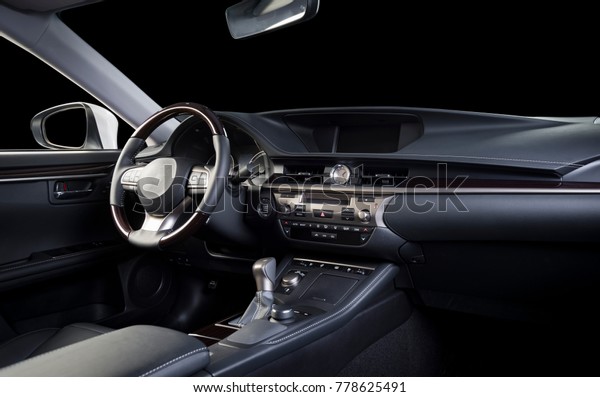 Modern luxury car  interior,\
dashboard, steering wheel, wood panels. Stitched black perforated \
leather interior, clipping path for isolated windows\
included.