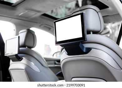 Modern luxury car interior with empty white touchscreen monitor with copy space.