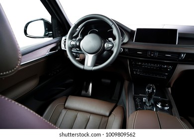 Modern luxury car Interior. Car inside. Steering wheel, dashboard, speedometer, display. Brown leather cockpit isolated on white with clipping path - Shutterstock ID 1009809562