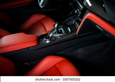 Modern luxury car Interior - steering wheel, shift lever and dashboard. Car interior luxury inside. Steering wheel, dashboard, speedometer, display. Sand orange red leather cockpit