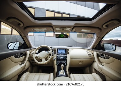 Modern luxury car Interior - steering wheel, shift lever and dashboard. Car interior luxury inside. Steering wheel, dashboard, speedometer, display.Yellow leather interior. White leather interior.