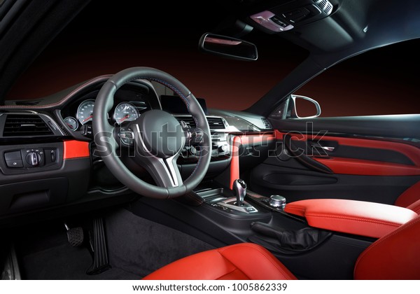 Modern luxury car
Interior - steering wheel, shift lever and dashboard. Car interior
luxury inside. Steering wheel, dashboard, speedometer, display. Red
and black leather
cockpit
