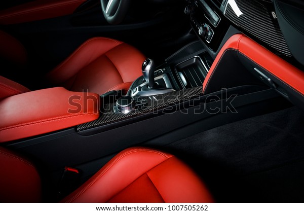 Modern luxury\
car Interior - steering wheel, shift lever and dashboard. Car\
interior luxury inside. Steering wheel, dashboard, speedometer,\
display. Sand orange red leather\
cockpit