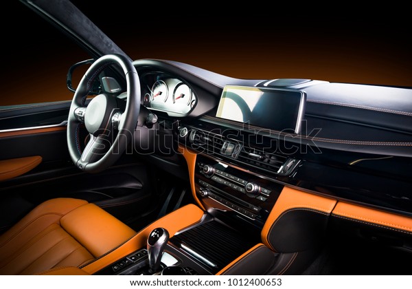 Modern luxury car
Interior - steering wheel, shift lever and dashboard. Car interior
luxury inside. Steering wheel, dashboard, speedometer, display. Red
and black leather
cockpit