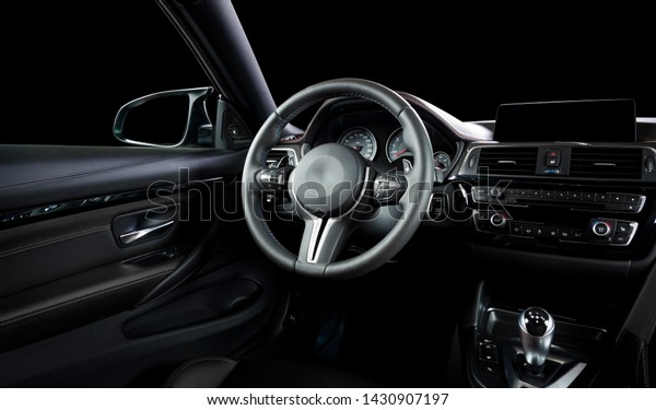 Modern luxury car Interior\
- steering wheel, shift lever and dashboard. Car interior luxury\
inside. Steering wheel, dashboard, speedometer, display. Black\
leather cockpit