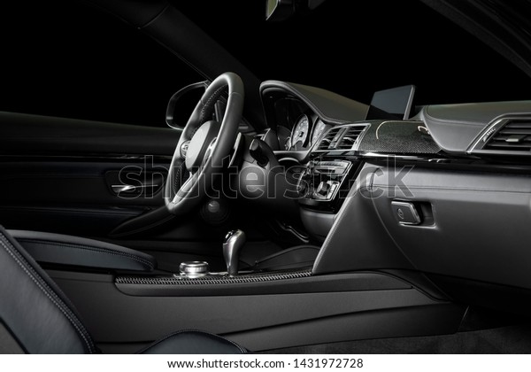 Modern luxury car\
Interior - steering wheel, shift lever and dashboard. Car interior\
luxury inside. Steering wheel, dashboard, speedometer, display.\
Yellow leather cockpit