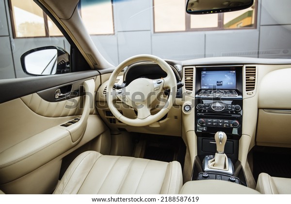 Modern luxury car Interior - steering wheel,
shift lever and dashboard. Car interior luxury inside. Steering
wheel, dashboard, speedometer, display.Yellow leather interior.
White leather interior.