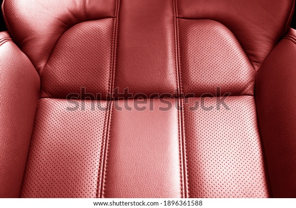 Modern\
luxury car red leather interior. Part of red leather car seat\
details with stitching. Interior of prestige car. Comfortable\
perforated leather seats. Perforated\
leather.