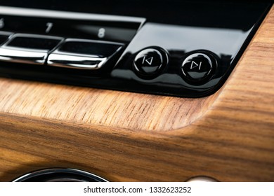 Modern Luxury Car White Interior With Natural Wood Panel. Part Of Dashboard. Interior Of Prestige Modern Car. Media Control Buttons. Car Detailing. Car Inside. Close Up