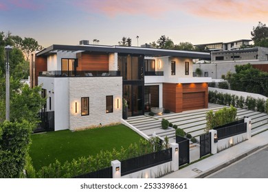 A modern luxury house with a well-manicured lawn and contemporary architecture at sunset. - Powered by Shutterstock