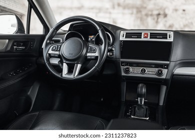 Modern luxury interior of car with leather seats big multimedia monitor dashboard and control panel view from rear seat row - Shutterstock ID 2311237823