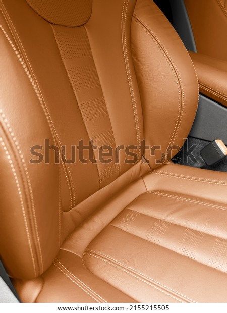 Modern\
luxury orange red leather interior. Part of red leather car seat\
details with stitching. Interior of prestige car. Comfortable brown\
perforated leather seats. Perforated\
leather.