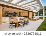 Modern luxury outdoor living space with elegant wooden furniture and open design, featuring a seamless transition to indoor areas.