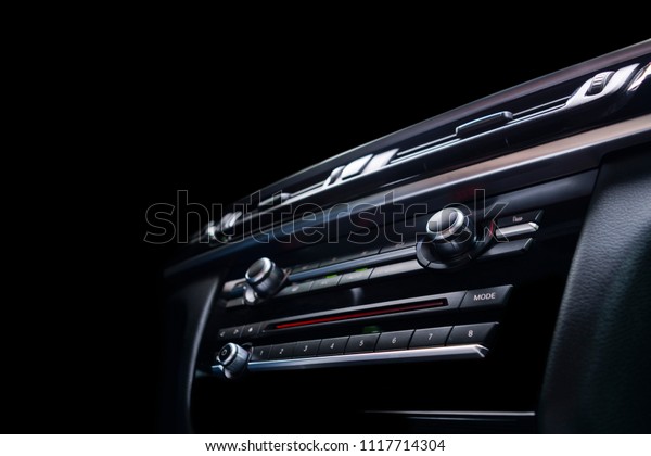 Modern Luxury sport car inside. Interior of\
prestige car. Black Leather. Car detailing. Dashboard. Media,\
climate and navigation control buttons. Sound system. Modern car\
interior details.