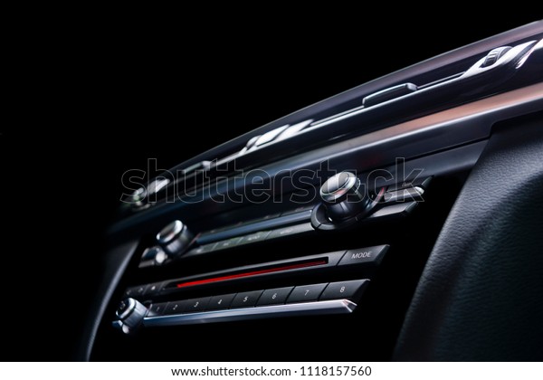 Modern\
Luxury sport car inside. Interior of prestige car. Black Leather.\
Car detailing. Dashboard. Media, climate and navigation control\
buttons. Sound system. Modern car interior\
details