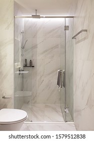 Modern luxury style bathroon interior decoration, Clear glass shower enclosure frameless design with white calacatta marbe tiles backdrop. - Shutterstock ID 1579512838