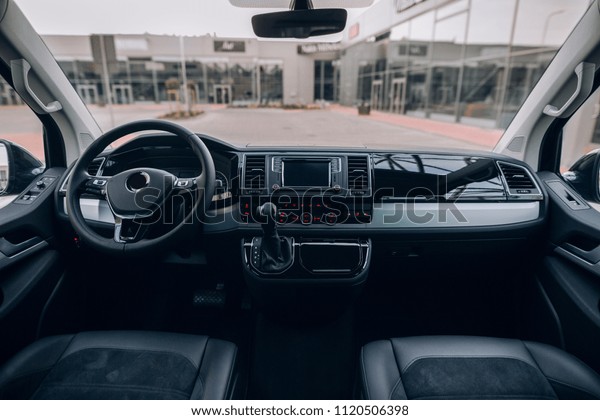 Modern and luxury van interior with black\
leather seats, steering wheel and\
dashboard.