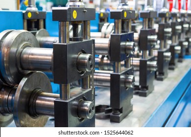 Modern Machine For The Manufacture Of Metal Profiles. The Main Working Bodies Of The Machine, Metal Rolls. Roller Mill With Many Round Steel Rollers.