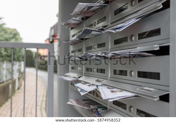 Modern mailboxes filled of\
flyers. Business and advertising concepts. Shallow depth of\
field.