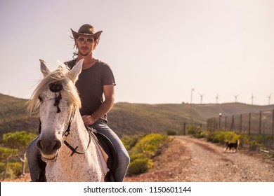 Modern Man Cowboy Enjoy A Natural And Alternative Lifestyle Riding A White Horse. Friendship And Nature Outdoor For Beautiful People Living A Different Life In The Rural Country Side