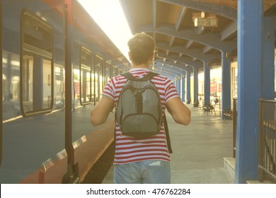 Modern man waiting train on railway station.