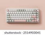 Modern mechanical keyboard on pink background. Minimal style and design keyboard. Custom build keyboard. Colorful key pastel creamy pink and green cap. Top view.