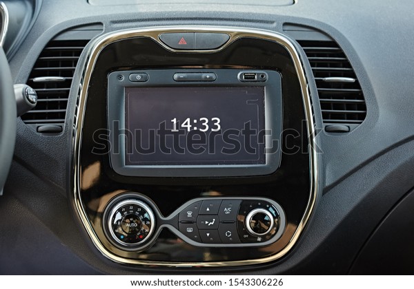 Modern media display in the\
interior of the car. Sensor screen with multimedia. Time\
clock