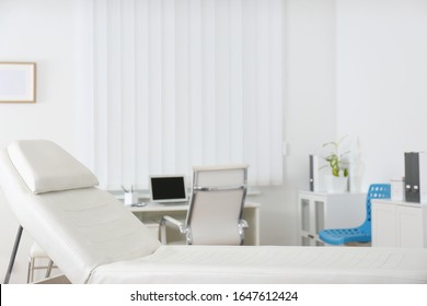 Modern medical examination couch in doctor's office