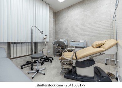 A modern medical examination room with specialized equipment for healthcare procedures, ensuring comfort and hygiene in a sterile environment - Powered by Shutterstock