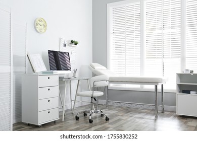 Modern Medical Office Interior With Computer And Examination Table