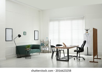 Modern Medical Office Interior With Doctor's Workplace And Sofa