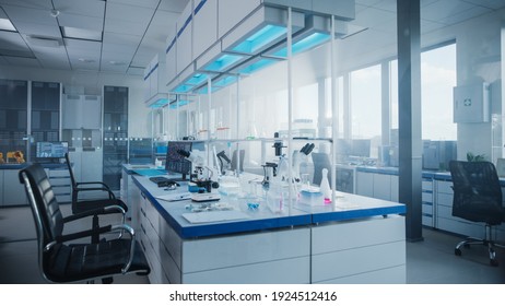 Modern Medical Research Laboratory with Computer, Microscope, Glassware with Biochemicals on the Desk. Scientific Lab Biotechnology Development Center Full of High-Tech Equipment.
