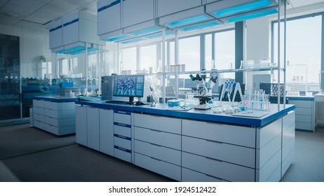 Modern Medical Research Laboratory with Computer, Microscope, Glassware with Biochemicals on the Desk. Scientific Lab Biotechnology Development Center Full of High-Tech Equipment. - Shutterstock ID 1924512422