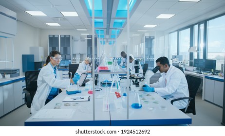 Modern Medical Research Laboratory: Diverse Team Of Scientists Working Using Microscope, Analysing Biochemicals Samples. Scientific Lab For Medicine, Microbiology Development. Advanced Equipment