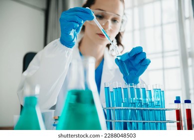 Modern medical research laboratory. female scientist working with micro pipettes analyzing biochemical samples, advanced science chemical laboratory 
 - Powered by Shutterstock