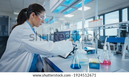 Modern Medical Research Laboratory: Female Scientist Working with Micro Pipette, Analysing Biochemicals Samples. Advanced Scientific Lab for Medicine, Microbiology Development.