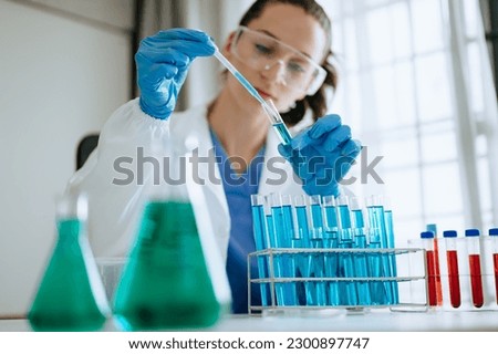 Modern medical research laboratory. female scientist working with micro pipettes analyzing biochemical samples, advanced science chemical laboratory for medicine. 
