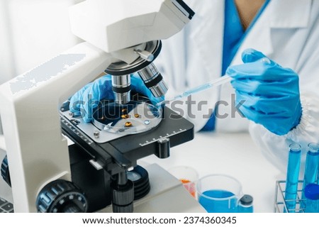 Modern medical research laboratory. female scientist working with micro pipettes analyzing biochemical samples, advanced science chemical laboratory for medicine. 
