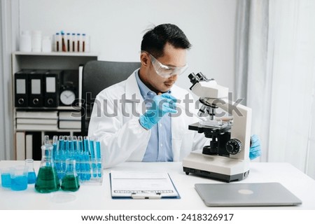 Modern medical research laboratory. male scientist working with micro pipettes analyzing biochemical samples, advanced science chemical laboratory for medicine. 
 Zdjęcia stock © 