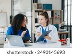 Modern Medical Research Laboratory Portrait of Two African American Scientists Working, Using Digital Tablet, Analyzing Samples, Talking. for Medicine, Biotechnology Development
