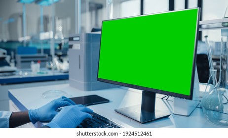 Modern Medical Research Laboratory: Scientist Working On Computer Showing Green Chroma Key Screen. Scientific Lab, Medicine Development Facility With Advanced Equipment, Biotechnology.