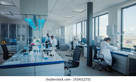Modern Medical Research Laboratory: Team of Scientists Working with Pipette, Analysing Microbiological Sample, Talking. Advanced Scientific Lab for Drugs, Microbiology Development. High-Tech Equipment - Shutterstock ID 1924512731
