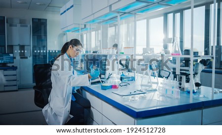 Modern Medical Research Laboratory: Team of Scientists Working with Pipette, Analysing Biochemicals Samples, Talking. Scientific Lab for Medicine, Microbiology Development. Advanced Equipment