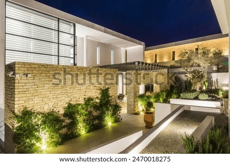 Similar – Image, Stock Photo A Mediterranean courtyard, the curved facade of a residential building and a delicate flower