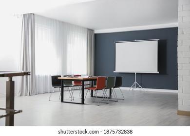 Modern Meeting Room Interior With Large Table And Projection Screen