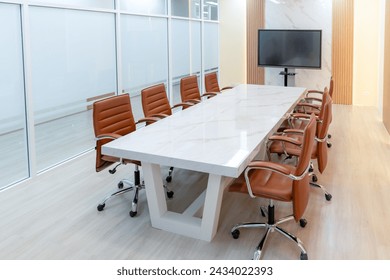 Modern meeting room interior with television for remote working. Modern white meeting table with chairs. Conference room surrounded by glass wall. No people. TV screen office background. Ornamented. - Powered by Shutterstock